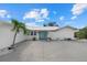 Charming home showcasing a blue entry door, well-manicured landscaping, and a paved driveway at 538 Magellan Dr, Sarasota, FL 34243