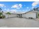 Charming exterior with manicured landscaping, metal roof, and ample parking space at 538 Magellan Dr, Sarasota, FL 34243