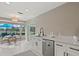 Modern kitchen with stainless steel appliances, white cabinetry, and pool view at 538 Magellan Dr, Sarasota, FL 34243