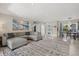 Open-concept living area with a cozy sectional, decorative rug, and view to the dining area at 538 Magellan Dr, Sarasota, FL 34243