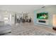 Open-concept living room with a fireplace, TV, and view of the dining area at 538 Magellan Dr, Sarasota, FL 34243