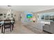 Open living room with dining area, tile floors, fireplace, and backyard access via sliding glass doors at 538 Magellan Dr, Sarasota, FL 34243