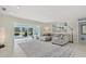 Bright and airy living room with comfortable seating and large sliding doors to the backyard pool area at 538 Magellan Dr, Sarasota, FL 34243