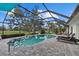Gorgeous screened-in pool with brick pavers and views of the lush green golf course at 538 Magellan Dr, Sarasota, FL 34243