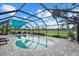 Beautiful pool area with comfortable seating and enclosed screen, great golf course views at 538 Magellan Dr, Sarasota, FL 34243