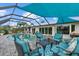 Relaxing outdoor space with refreshing pool, shaded seating area, and lush landscaping at 538 Magellan Dr, Sarasota, FL 34243