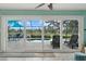 Sliding glass doors open to a stunning screened pool, luxurious lounge chairs and lush golf course views at 538 Magellan Dr, Sarasota, FL 34243