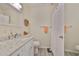 Bathroom featuring a white granite vanity, toilet, and tiled shower with updated fixtures at 548 Lakeside Dr # 0, Bradenton, FL 34210