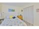 Cozy bedroom featuring a white bed frame, side table, and closet with shutter doors at 548 Lakeside Dr # 0, Bradenton, FL 34210