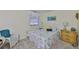 Bright bedroom with a cozy chair, bamboo side table, and closet with shutter doors at 548 Lakeside Dr # 0, Bradenton, FL 34210