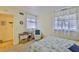 Light-filled bedroom with a wicker chair, glass table, and sunny window view at 548 Lakeside Dr # 0, Bradenton, FL 34210