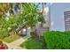 Condominium building featuring mature trees and lush landscaping at 548 Lakeside Dr # 0, Bradenton, FL 34210
