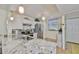 Well-lit kitchen boasts stainless steel appliances, white cabinetry, and a large granite countertop at 548 Lakeside Dr # 0, Bradenton, FL 34210