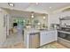 Open kitchen with stainless steel appliances, granite counters, and breakfast bar open to the living area at 548 Lakeside Dr # 0, Bradenton, FL 34210