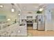Open kitchen with stainless steel appliances, granite counters, and ample cabinet space at 548 Lakeside Dr # 0, Bradenton, FL 34210