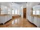 Opulent primary bathroom with dual vanities, large mirrors, chandelier, and a raised platform soaking tub at 550 Dove Pointe, Osprey, FL 34229