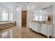 Lavish bathroom showcasing dual vanities, decorative mirrors, walk-in shower, and a relaxing soaking tub at 550 Dove Pointe, Osprey, FL 34229