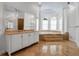 Bright bathroom featuring a soaking tub on a raised platform, large windows, and elegant vanity at 550 Dove Pointe, Osprey, FL 34229