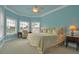 Relaxing bedroom with a plush bed, bright windows, and calming blue walls and trim at 550 Dove Pointe, Osprey, FL 34229