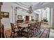 Expansive dining room featuring an ornate chandelier, a large table, and elegant columns at 550 Dove Pointe, Osprey, FL 34229