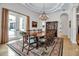 Elegant dining room featuring a long table, chandelier, and French doors leading to the outside at 550 Dove Pointe, Osprey, FL 34229