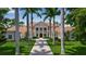 Elegant home featuring manicured lawn, brick walkway, and stately columns leading to the inviting front entrance at 550 Dove Pointe, Osprey, FL 34229
