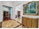Elegant foyer with marble floors, a decorative console, and a large painting at 550 Dove Pointe, Osprey, FL 34229