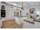 Bright kitchen featuring white cabinets, granite countertops, and multiple islands at 550 Dove Pointe, Osprey, FL 34229