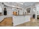 Well-lit kitchen with custom cabinets, a large island, and modern appliances at 550 Dove Pointe, Osprey, FL 34229