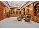 Handsome library with wood paneling, fireplace and custom built-ins at 550 Dove Pointe, Osprey, FL 34229