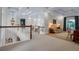 Open loft area with coffered ceilings, cozy seating, a view of the staircase, and ample natural light at 550 Dove Pointe, Osprey, FL 34229