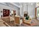 Elegant living room featuring a warm fireplace, sophisticated decor, and seamless access to multiple rooms at 550 Dove Pointe, Osprey, FL 34229