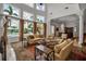 Bright living room with vaulted ceilings, stylish decor, and views of the outdoor pool and landscaping at 550 Dove Pointe, Osprey, FL 34229