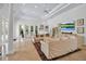 Spacious living room with travertine floors, detailed ceiling and plush sofas at 550 Dove Pointe, Osprey, FL 34229