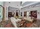 Expansive living room with high ceilings, stylish furnishings, and open layout leading to the dining area at 550 Dove Pointe, Osprey, FL 34229
