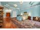 Large main bedroom with blue walls, unique ceiling, and a comfortable bed at 550 Dove Pointe, Osprey, FL 34229