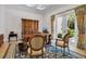 Spacious home office featuring a large wooden desk, ornate rug, and backyard view at 550 Dove Pointe, Osprey, FL 34229