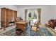 Spacious home office with a large wooden desk, ornate rug, and backyard view at 550 Dove Pointe, Osprey, FL 34229
