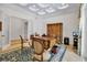 Well-appointed home office with a classic wooden desk, storage cabinet, and ample natural light at 550 Dove Pointe, Osprey, FL 34229