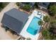 Aerial view of a home with a backyard pool and lush landscaping at 6005 N Beach Rd # 16, Englewood, FL 34223