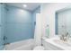 Bright bathroom with stylish blue tile, shower-tub, updated vanity, and well-lit mirror for a refreshing and clean experience at 6005 N Beach Rd # 16, Englewood, FL 34223