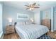 Serene bedroom featuring a comfortable king-size bed, ceiling fan, and natural light at 6005 N Beach Rd # 16, Englewood, FL 34223
