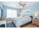Comfortable bedroom featuring a ceiling fan, serene wall art, and plush bedding for restful nights at 6005 N Beach Rd # 16, Englewood, FL 34223