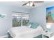 Tranquil bedroom featuring a charming mermaid painting, serene water view, and refreshing turquoise accents for a calming coastal vibe at 6005 N Beach Rd # 16, Englewood, FL 34223