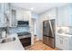 Updated kitchen featuring stainless steel appliances, quartz counters, and shaker style cabinets at 6005 N Beach Rd # 16, Englewood, FL 34223