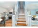 Stylish kitchen featuring stainless steel appliances, and adjacent staircase to the second floor at 6005 N Beach Rd # 16, Englewood, FL 34223