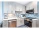 Bright kitchen featuring stainless steel appliances, and updated cabinetry with a beautiful backsplash at 6005 N Beach Rd # 16, Englewood, FL 34223