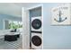 Convenient laundry area with stacked washer and dryer, located near the living area at 6005 N Beach Rd # 16, Englewood, FL 34223