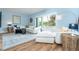 Bright living area featuring comfortable seating, nautical decor and a sliding glass door with beautiful natural lighting and access to the outdoors at 6005 N Beach Rd # 16, Englewood, FL 34223