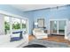 Bright living room featuring large windows, hardwood floors, and stylish, comfortable white furniture at 6005 N Beach Rd # 16, Englewood, FL 34223